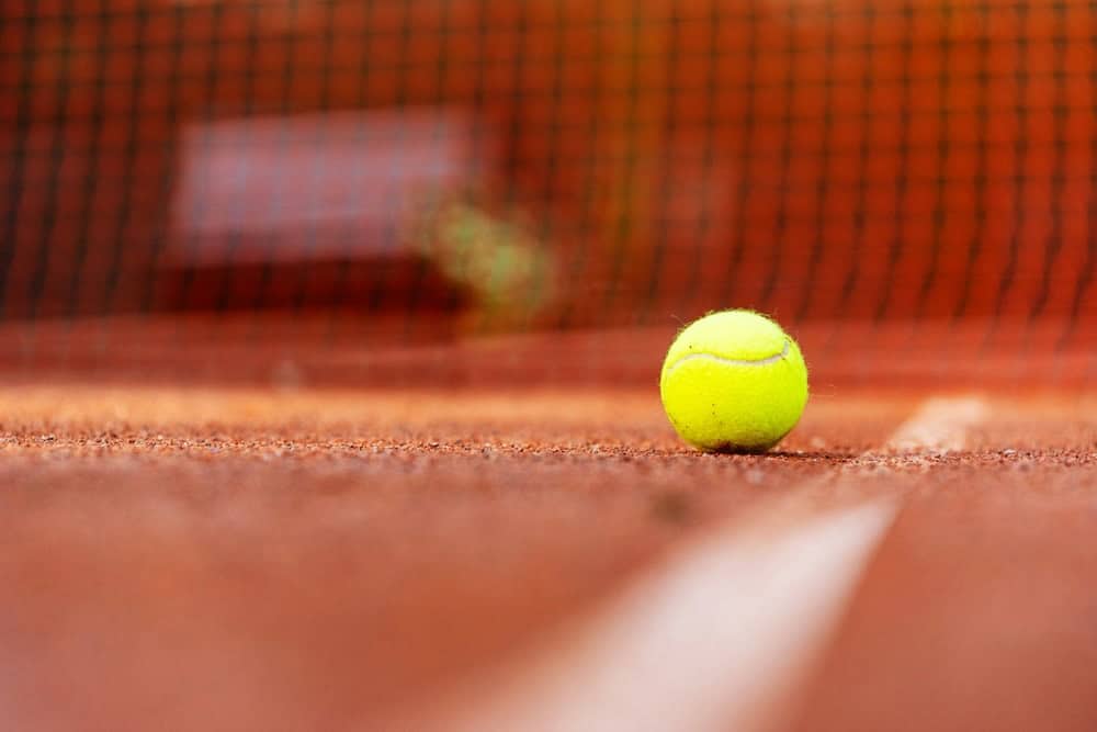A tennis court with a clay surface