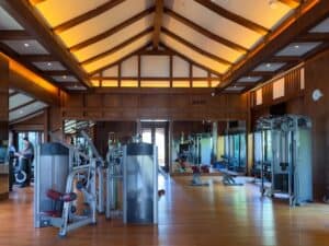 A modern and fully stocked fitness center with a unique design and use of light