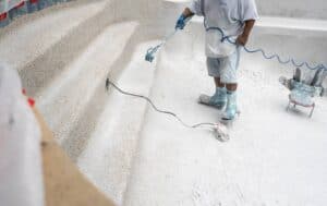 Professional tiling on a pool interior wall as part of a complete pool resurfacing renovation