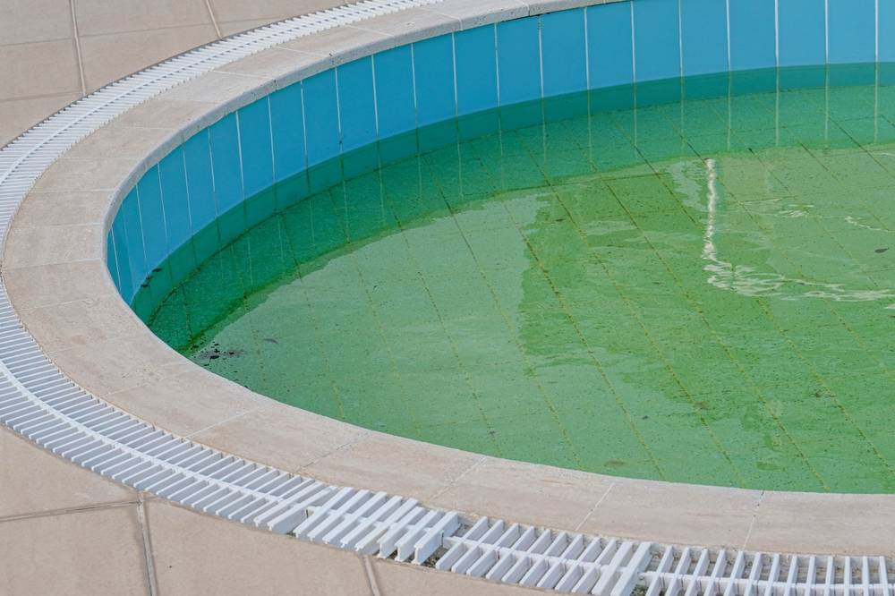 A pool covered in dust and sand showing how sandstorms affect water clarity
