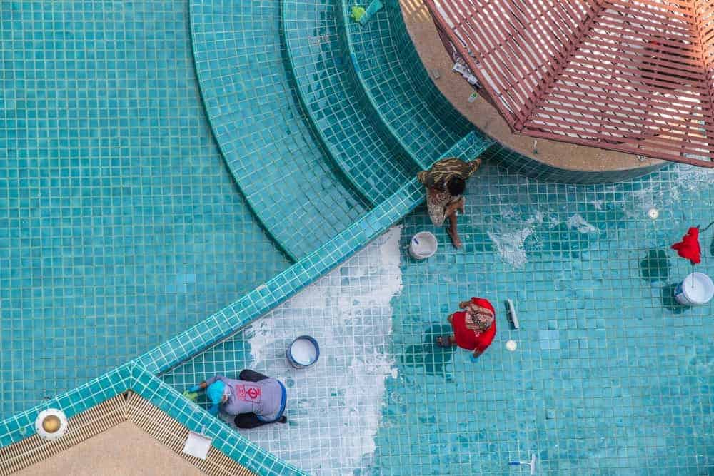 A residential pool transformed by modern pool remodeling ideas with elegant finishes and updated surroundings