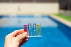 Conducting pool water testing for pH level