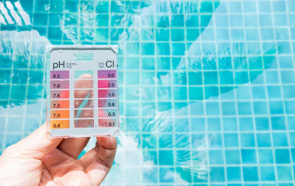 A staff is testing alkalinity level before deciding how to raise alkalinity in pool
